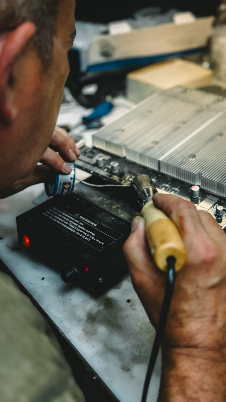 Electrician repairing an electrical circuit board